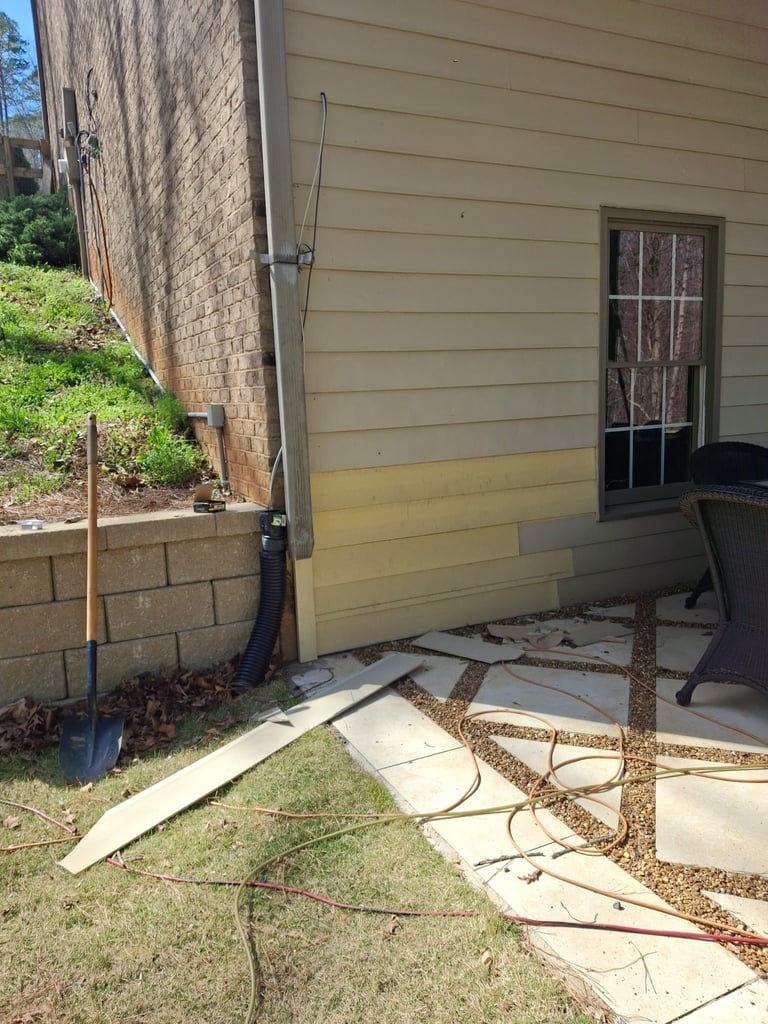 Back patio area with cream-colored house siding